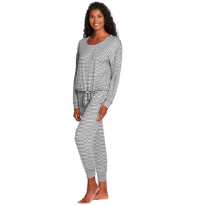 Woman wearing a comfortable striped lounge outfit standing barefoot, showcasing the Jogger Sleep Set - 2PC | Lemon in a relaxed pose.