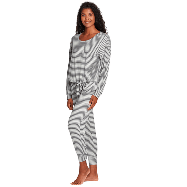 Woman wearing a comfortable striped lounge outfit standing barefoot, showcasing the Jogger Sleep Set - 2PC | Lemon in a relaxed pose.