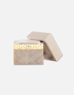 Soap bar with a natural stone-like texture and a yellow patterned label, displayed with a matching stone-inspired case, showcasing the Concreta | Zents brand.