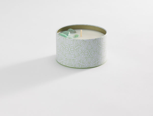 Bloom Candle Tin 6 oz | Aluminate Life featuring a decorative white and light green patterned tin with a single wick and a small green crystal on the candle surface, evoking wellness and relaxation.