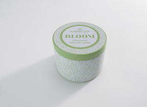 Bloom Candle Tin 6 oz | Aluminate Life with a light green lid and geometric patterned white container, designed for wellness and relaxation ambiance.