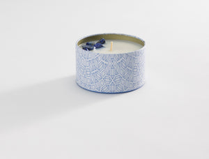 Calm Candle Tin 6 oz | Aluminate Life with a geometric patterned blue and white tin container and decorative blue crystal accents on the surface of the white wax.