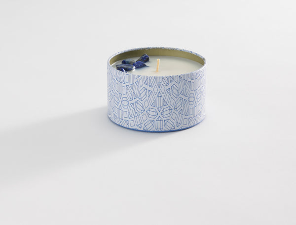 Calm Candle Tin 6 oz | Aluminate Life with a geometric patterned blue and white tin container and decorative blue crystal accents on the surface of the white wax.