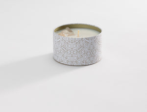 Defense Candle Tin 6 oz | Aluminate Life featuring a decorative white tin with gold geometric patterns, filled with a cream-colored candle and a single wick.