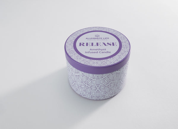 Release Candle Tin 6 oz | Aluminate Life featuring a purple and white patterned tin with amethyst-infused candle for wellness and relaxation.