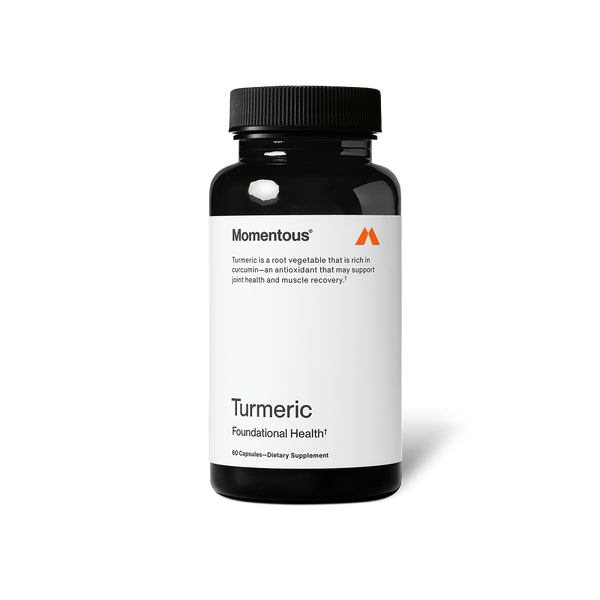 A black bottle of dietary supplement labeled Turmeric by Momentous, promoting joint health and muscle recovery with antioxidant properties.