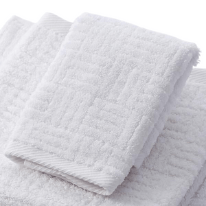 Soft white towel with textured pattern made from Hotel Collection Organic Cotton | TOWL, designed for ultimate comfort and sustainable body care.