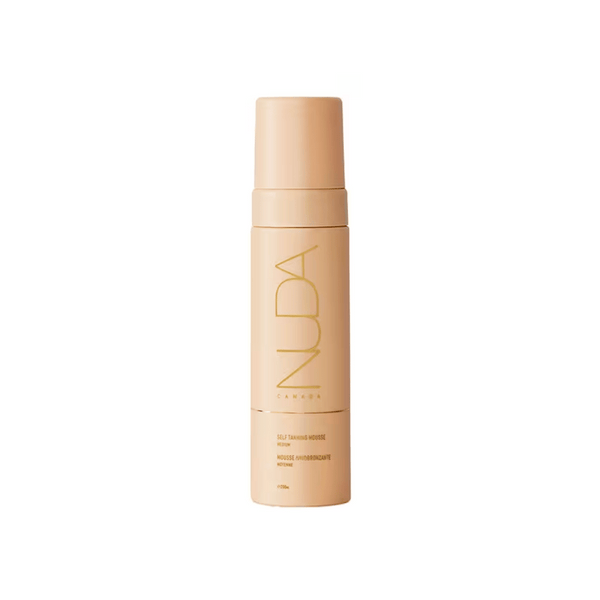Minimalist beige bottle of Self Tanning Mousse | NUDA designed for skincare and body care, featuring elegant gold lettering on the front.