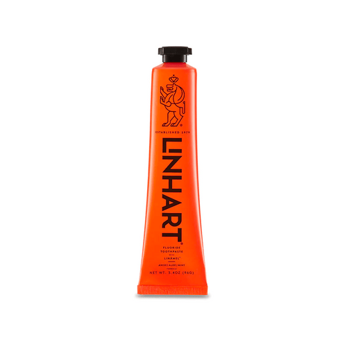 Orange tube of Linämel Toothpaste | LINHART with black cap and bold black lettering, featuring a stylized lion logo and 3.4 oz net weight on a white background.