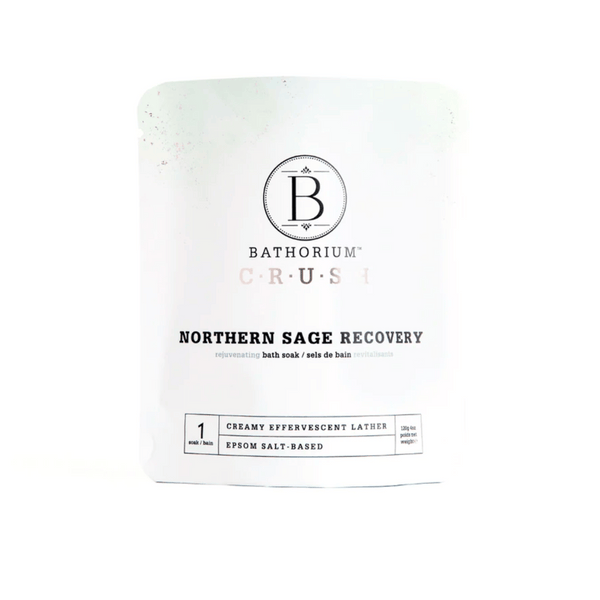 White resealable pouch of Northern Sage Recovery Crush | Bathorium, an Epsom salt-based bath soak for skincare and body recovery with creamy effervescent lather.