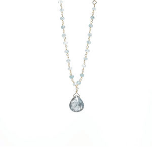 Delicate necklace featuring light blue beads and a teardrop-shaped pendant with a textured surface, designed as the Alice Rosary Necklace | Liv & B.