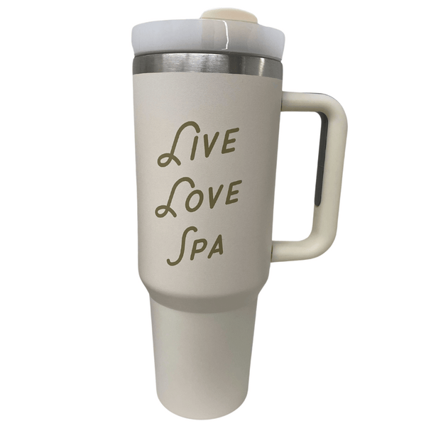 Cream-colored insulated tumbler with handle and spill-proof lid featuring the text Live Love Spa, designed for wellness and hydration, Live Love Spa Retro 40 oz Tumbler | Live Love Spa.