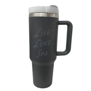 Black insulated travel mug with handle and white lid featuring "Live Love Spa" text, designed for hydration during skincare and wellness routines, Live Love Spa Retro 40 oz Tumbler | Live Love Spa.