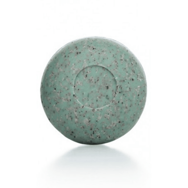 Round green speckled bar of Seaweed Soap | Phytomer on a white background, designed for skincare and body care use.