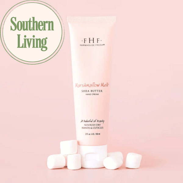 Tube of Marshmallow Melt Hand Cream | Farmhouse Fresh with shea butter surrounded by marshmallows on a soft pink background next to a Southern Living logo, highlighting skincare and body care.