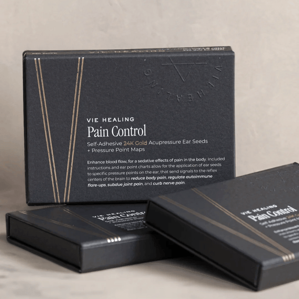 Black boxes of Pain Conrol - 24K Gold Ear Seed | Vie Healing product with gold line accents, designed for acupressure and pain relief using self-adhesive ear seeds.