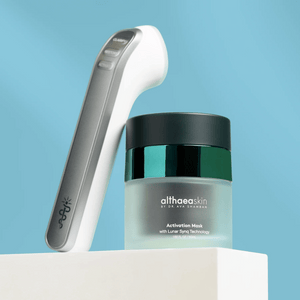 C·A·R·A Multi-Modal Tool Kit | Althaea Skin featuring a sleek skincare device and a jar of Activation Mask with Lunar Sync Technology for advanced body care and wellness.