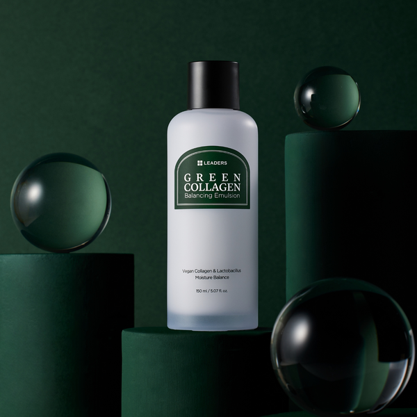 Bottle of Green Collagen Balancing Emulsion | Leaders displayed on dark green cylindrical platforms with reflective glass spheres, highlighting skincare and wellness.