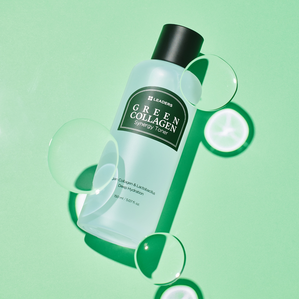 Bottle of Green Collagen Synergy Toner | Leaders on a green background with water droplets, highlighting skincare and hydration benefits.
