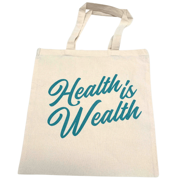 Beige fabric tote bag with teal script text reading "Health is Wealth" featured on the Health is Wealth Tote | Lucky Owl, ideal for carrying wellness supplements and body care products.
