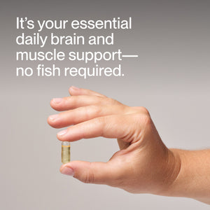 Hand holding a clear capsule supplement with text highlighting Vegan Omega-3 as essential daily brain and muscle support without using fish.
