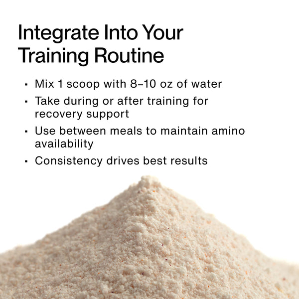 Close-up of a light beige powder with text instructions on how to use Vital Aminos for training routines, including mixing one scoop with water, taking it during or after exercise, using between meals, and emphasizing consistency for best results.