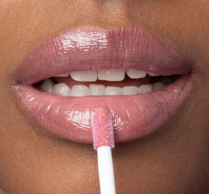 Close-up of lips with a soft pink gloss being applied, showcasing the shine and moisturizing effect of Vitamin Glaze® Oil Infused Lip Gloss – Delicate Rose | Farmhouse Fresh.