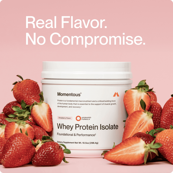 Whey Protein Isolate - Flavor Series container surrounded by fresh strawberries with the text "Real Flavor. No Compromise." on a soft pink background.
