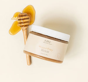 Jar of whipped honey body polish with wooden honey dipper and honey drizzled next to it, featuring Honey I’m Smooth Limited Edition Set | Farmhouse Fresh for skincare and body care.