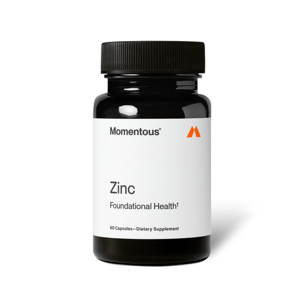 Bottle of Zinc dietary supplement by Momentous with white label and black cap, promoting foundational health and wellness.