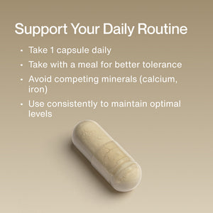 Close-up of a single capsule supplement on a beige background with text explaining how to use Zinc daily by taking one capsule with a meal and avoiding competing minerals for optimal wellness.