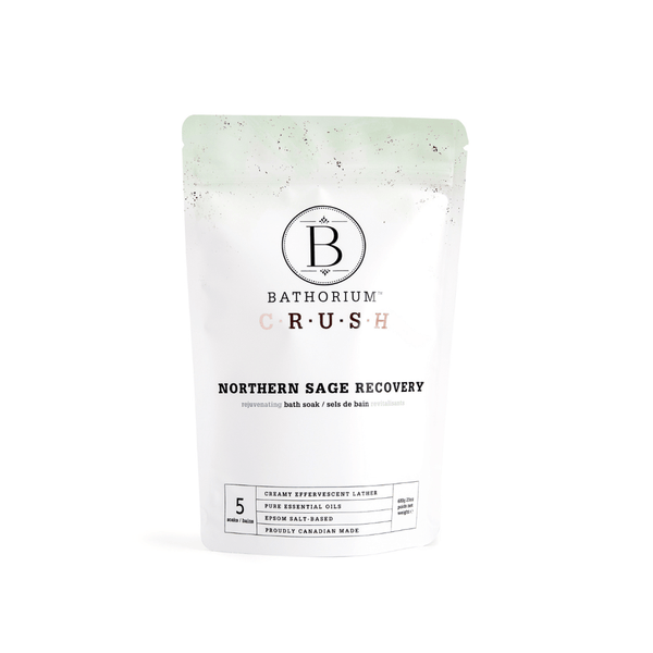 Packaging of Northern Sage Recovery Crush | Bathorium, a bath soak product designed for rejuvenating skincare and body care, featuring clean white and light green colors with essential oils and Epsom salt blend.