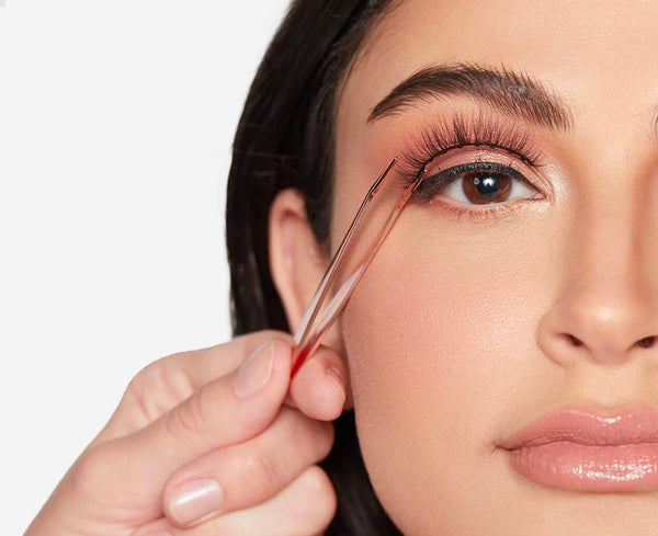 Close-up of a woman applying individual eyelashes with the Lash Applicator - Rose Gold | Moxielash, highlighting precision and ease for flawless lash application.