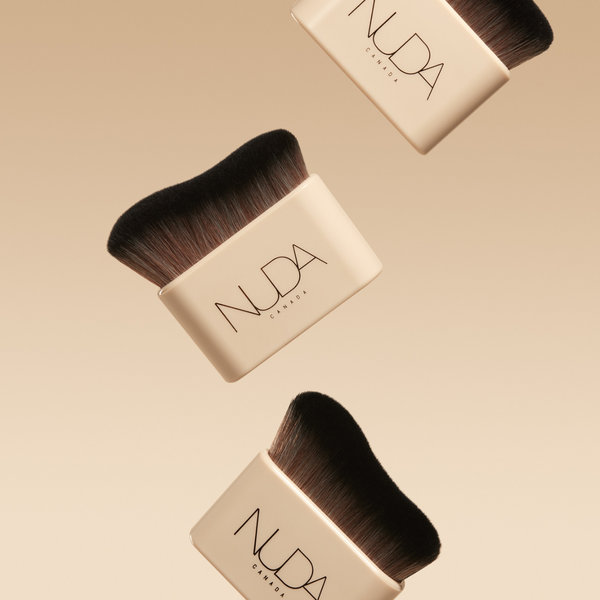 Blending Brush | NUDA featuring soft, densely packed bristles with a sleek cream-colored handle designed for smooth and flawless makeup application.