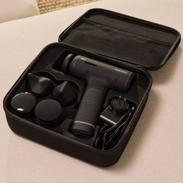 Black Hypervolt 3 | Hyperice percussion massage device with multiple attachment heads and charger neatly stored in a black carrying case for body care and recovery.