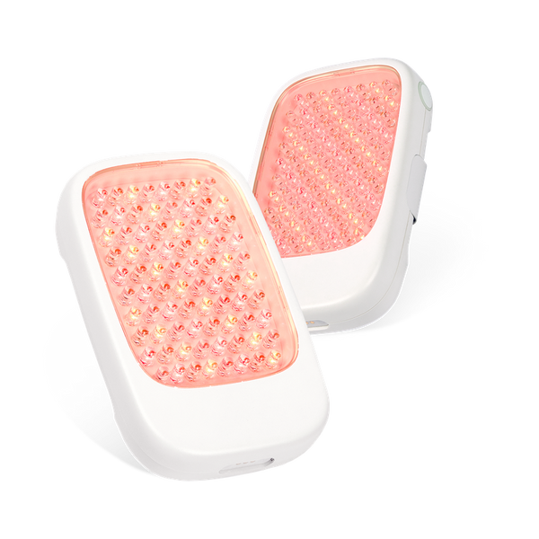 Two white handheld wellness devices with glowing red light panels, designed for skincare and recovery, labeled Recovery Loop | LightStim.