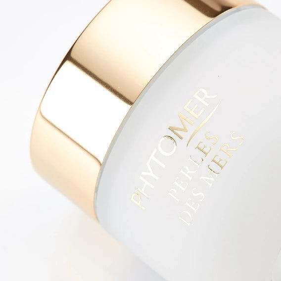 Close-up of a skincare jar with a gold lid featuring Perles Des Mers Longevity Cream | Phytomer, highlighting luxury body care packaging.