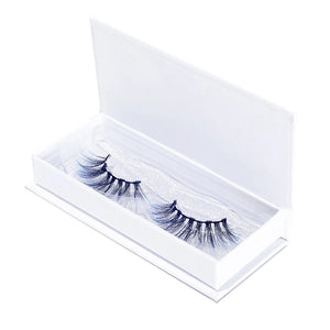Pair of elegant black and silver false eyelashes displayed in a white open box, showcasing the Stormy Lash - Colored | Moxielash for a striking beauty look.
