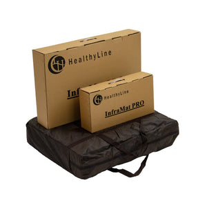 Packaging boxes of the TAJ-Mat™ Full 7224 Firm - Photon PEMF InfraMat Pro® | HealthyLine displayed on a folded dark carrying case, showcasing wellness device accessories.