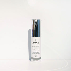Bottle of AGELESS total eye lift crème | IMAGE Skincare with a silver pump dispenser against a clean white background, highlighting premium skincare for the eye area.