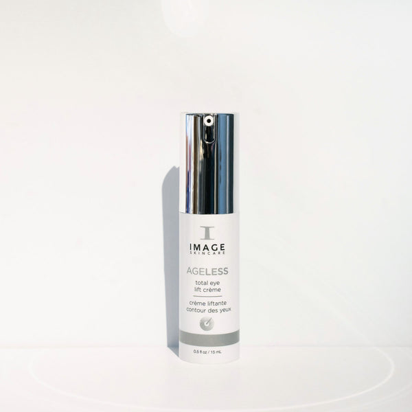 Bottle of AGELESS total eye lift crème | IMAGE Skincare with a silver pump dispenser against a clean white background, highlighting premium skincare for the eye area.