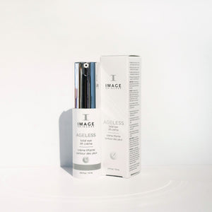 Bottle and box of AGELESS total eye lift crème | IMAGE Skincare with sleek white and silver packaging on a clean white background, highlighting skincare and wellness.