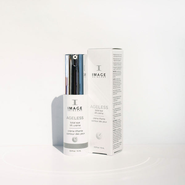 Bottle and box of AGELESS total eye lift crème | IMAGE Skincare with sleek white and silver packaging on a clean white background, highlighting skincare and wellness.