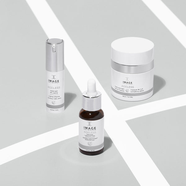 Three IMAGE Skincare AGLESS total eye lift crème | IMAGE Skincare products displayed on a light surface, featuring a pump bottle, dropper bottle, and jar, representing skincare and body care items.