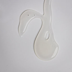 Clear gel texture sample of Purifying Gel Cleanser | Alchimie Forever on a white background, highlighting its smooth, lightweight skincare formula.