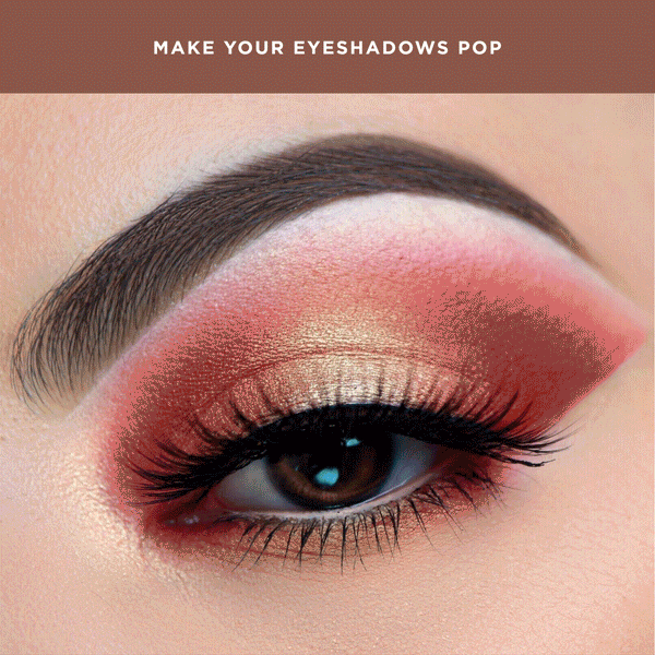 Close-up of an eye featuring vibrant pink and gold eyeshadow with defined lashes and brows, demonstrating the effect of Uncaged Eyeshadow Primer | Pretty Vulgar to make eyeshadows pop.