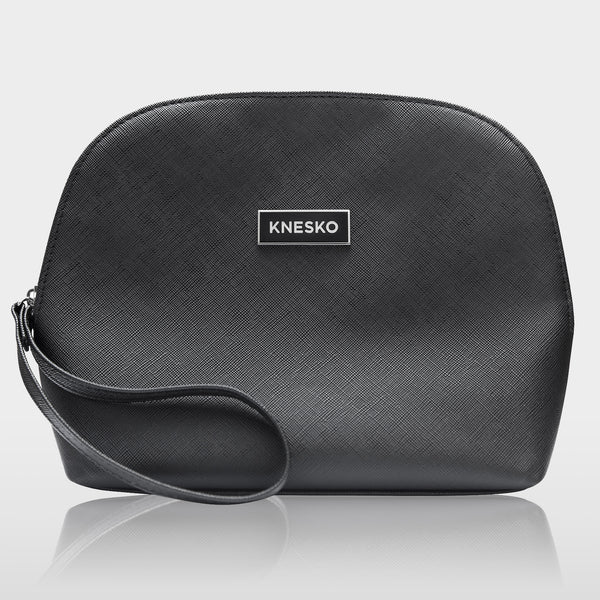 Black textured cosmetic bag with a wrist strap and a Knesko logo, designed to hold the Nanogold Repair Discovery Kit | Knesko for skincare and wellness essentials.