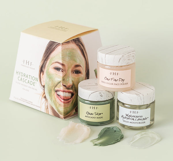 Hydration Cascade® 3-step Instant Spa Facial | Farmhouse Fresh featuring three skincare jars with avocado mask, sugar face polish, and hydration gel moisturizer alongside a box with a smiling woman wearing a green face mask