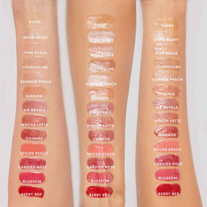 Swatches of twelve shades of Hydropure Hyaluronic Lip Gloss | Jane Iredale applied on three arms, showing glossy, sheer to bold colors ranging from neutrals and peaches to reds and berry tones.