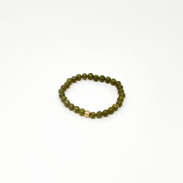 Assorted Satya Bracelets | Satya featuring a simple green beaded design with a single gold bead accent, perfect for enhancing your wellness accessory collection.